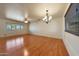 Spacious living room featuring hardwood floors, ceiling fan, and ample natural light at 10650 W Riviera Dr, Sun City, AZ 85351