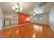 Open-concept living room featuring hardwood floors, neutral walls, and modern light fixtures at 10650 W Riviera Dr, Sun City, AZ 85351