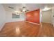 Open-concept living room featuring hardwood floors, modern light fixtures, and neutral walls at 10650 W Riviera Dr, Sun City, AZ 85351