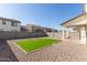 Backyard featuring gravel landscaping, patio area, and an artificial grass space at 10983 W Mckinley St, Avondale, AZ 85323