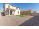 Backyard featuring gravel landscaping, patio area, and an artificial grass space at 10983 W Mckinley St, Avondale, AZ 85323