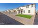 Backyard featuring gravel landscaping, patio area, and an artificial grass space at 10983 W Mckinley St, Avondale, AZ 85323