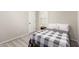 Bedroom featuring neutral colors, natural light, and a checkered gray and white comforter at 10983 W Mckinley St, Avondale, AZ 85323