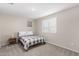 Bedroom featuring neutral colors, natural light, and a checkered gray and white comforter at 10983 W Mckinley St, Avondale, AZ 85323