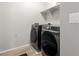 Laundry room featuring tile floors and new front loading washer and dryer at 10983 W Mckinley St, Avondale, AZ 85323