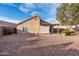 Spacious backyard with desert landscaping and a covered patio at 11955 W Granada Rd, Avondale, AZ 85392