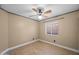 Neutral bedroom with a ceiling fan, wood-look flooring, and a window offering natural light at 11955 W Granada Rd, Avondale, AZ 85392