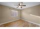 Cozy bedroom with a ceiling fan, a window with blinds, and wood-look flooring at 11955 W Granada Rd, Avondale, AZ 85392