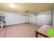 Well-lit garage with painted floors, an insulated door, and ample open space at 11955 W Granada Rd, Avondale, AZ 85392