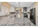 Spacious kitchen with granite countertops, modern cabinets, and stainless steel appliances at 11955 W Granada Rd, Avondale, AZ 85392