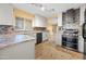 Modern kitchen with stainless steel appliances, granite countertops, and mosaic tile backsplash at 11955 W Granada Rd, Avondale, AZ 85392