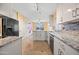 Bright kitchen features granite countertops, stainless steel appliances, and tile backsplash at 11955 W Granada Rd, Avondale, AZ 85392