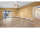 Spacious living room features tile flooring, ceiling fan, sliding glass doors, and light yellow walls at 11955 W Granada Rd, Avondale, AZ 85392