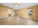 Spacious living room features tile flooring, light yellow walls, ceiling fan, and multiple windows at 11955 W Granada Rd, Avondale, AZ 85392