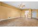 Spacious living room features tile flooring, light yellow walls, and multiple access points at 11955 W Granada Rd, Avondale, AZ 85392