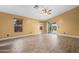 Spacious living room features tile flooring, multiple windows, ceiling fan, and sliding glass doors at 11955 W Granada Rd, Avondale, AZ 85392