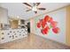 Open living room leads to the kitchen with views of modern appliances and bright lighting at 11955 W Granada Rd, Avondale, AZ 85392