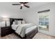 Cozy bedroom with plush carpeting, natural light, and a decorative ceiling fan at 12236 N 59Th St, Scottsdale, AZ 85254