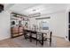 Bright dining room with modern lighting, decorative shelving and sliding glass door to backyard at 12236 N 59Th St, Scottsdale, AZ 85254