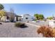 Modern home featuring a white facade, desert landscaping, and a covered entryway at 12236 N 59Th St, Scottsdale, AZ 85254