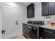 Modern laundry room with stainless steel appliances, sleek cabinetry, and ample counter space at 12236 N 59Th St, Scottsdale, AZ 85254