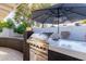 Turbo outdoor grill on custom island with white countertop and black brick base at 12236 N 59Th St, Scottsdale, AZ 85254