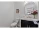 Charming powder room features a sleek vanity with gold hardware and decor accents at 12236 N 59Th St, Scottsdale, AZ 85254