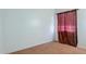 Cozy bedroom featuring neutral carpet and a window with elegant drapes at 12246 W Bloomfield Rd, El Mirage, AZ 85335