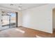 Bedroom with a ceiling fan, neutral walls, and sliding door to backyard at 12246 W Bloomfield Rd, El Mirage, AZ 85335