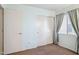 Bedroom with a carpeted floor, natural light, and double door closet at 12246 W Bloomfield Rd, El Mirage, AZ 85335