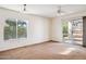 Spacious bedroom featuring a sliding glass door leading to the backyard at 12246 W Bloomfield Rd, El Mirage, AZ 85335