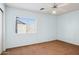 Bedroom featuring a ceiling fan and a window overlooking the backyard at 12246 W Bloomfield Rd, El Mirage, AZ 85335