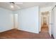 Bedroom featuring a ceiling fan and a hallway at 12246 W Bloomfield Rd, El Mirage, AZ 85335