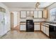 Bright kitchen with white cabinetry and access to dining area at 12246 W Bloomfield Rd, El Mirage, AZ 85335