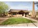 Charming single-story home showcases a lush front yard with mature trees and manicured landscaping at 130 W Palm Ln, Phoenix, AZ 85003