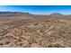 Aerial view highlights property lines amidst the arid landscape, with mountains in the background at 13502 E Jomax Rd, Scottsdale, AZ 85262