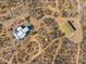 Birds-eye view features a modern home with an adjacent outbuilding, revealing the desert setting at 13502 E Jomax Rd, Scottsdale, AZ 85262