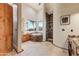 A luxurious bathroom features a soaking tub, walk-in shower, and knotty wood cabinets at 13502 E Jomax Rd, Scottsdale, AZ 85262