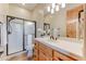 Bathroom featuring a walk-in shower with glass door and a white tile surround at 13502 E Jomax Rd, Scottsdale, AZ 85262