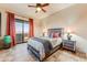 Beautifully staged bedroom with balcony access showcasing the neutral colors and decor at 13502 E Jomax Rd, Scottsdale, AZ 85262