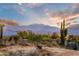 Scenic desert landscape with saguaro cacti and a mountain range under a vibrant sky at sunset at 13502 E Jomax Rd, Scottsdale, AZ 85262