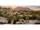 Desert landscape featuring native vegetation with a large rock formation silhouetted against a sunset sky at 13502 E Jomax Rd, Scottsdale, AZ 85262