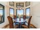 Dining area features a statement light fixture and desert views at 13502 E Jomax Rd, Scottsdale, AZ 85262