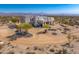 Exterior shot of a modern house with drought-resistant landscaping and native desert vegetation at 13502 E Jomax Rd, Scottsdale, AZ 85262