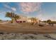 Exterior view of a custom home with desert landscaping at twilight at 13502 E Jomax Rd, Scottsdale, AZ 85262