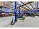 Spacious garage featuring a vehicle lift, motorcycles, and side by side at 13502 E Jomax Rd, Scottsdale, AZ 85262