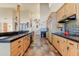 Modern kitchen featuring natural wood cabinets, tile floors, and stainless steel appliances at 13502 E Jomax Rd, Scottsdale, AZ 85262