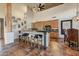 Open concept kitchen with rustic cabinets, large island with seating, and unique architectural details at 13502 E Jomax Rd, Scottsdale, AZ 85262