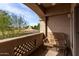 Relaxing balcony featuring a chair, privacy wall, and scenic outdoor views of trees and landscaping at 14000 N 94Th St # 1118, Scottsdale, AZ 85260