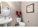 Convenient half-bath with pedestal sink, toilet, and neutral decor at 14000 N 94Th St # 1118, Scottsdale, AZ 85260